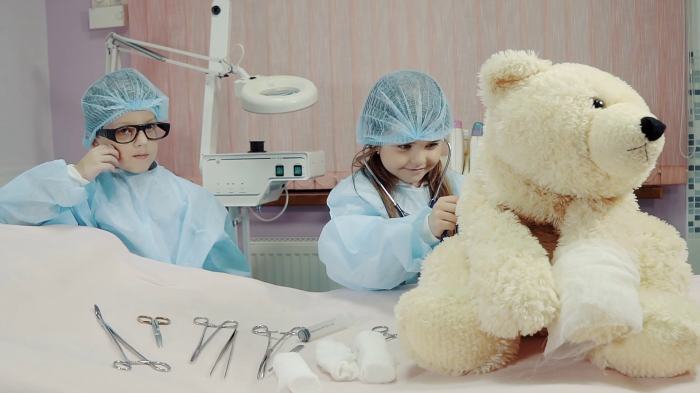 videoblocks-nice-children-dressed-as-doctors-are-playing-clinic-in-the-room-little-nurse-is-examining-on-a-toy-bear_bqb1fc8xvm_thumbnail-full01